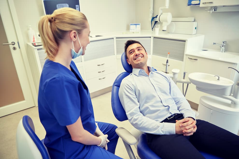 Man sitting in a dental chair smiling